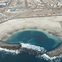 Two large-format SoilTain Tubes completely covered with armourstone as breakwaters in the sea