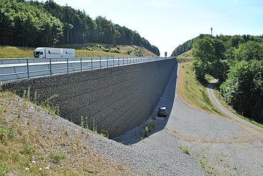 Completed support structure alongside a motorway.