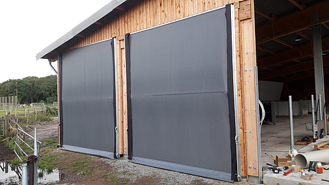 Roller shutters as wind and weather protection in the passage openings of the new hall building