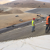 Construction workers lay and fill Incomat® filter point concrete mat