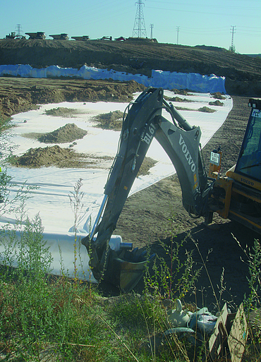 Several mounds of earth spread by an excavator on Stabilenka