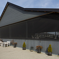 Windbreak net as weather protection at the indoor riding arena