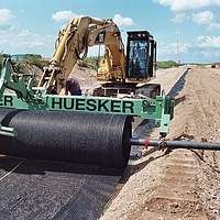 Fortrac Geogrid is laid by means of a laying traverse for soil reinforcement