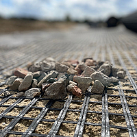 Close up of Basetrac Grid geogrid with small stones on it