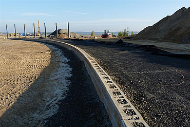 A reinforced retaining structure along a riverbank.