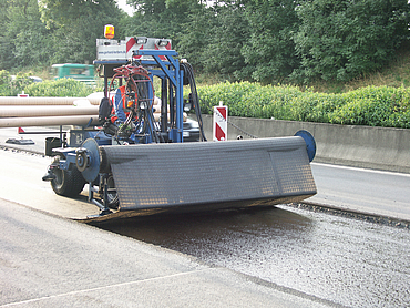 Unrolling of the geogrid by a construction machine.