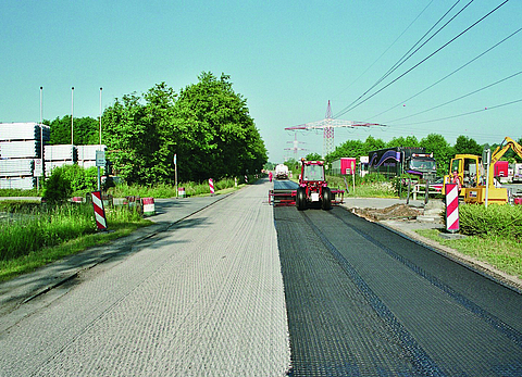 HaTelit is unrolled from a roll using a tractor