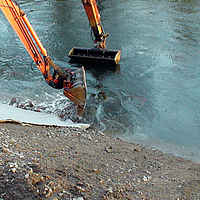 Excavation work at the water's edge for bank protection measures