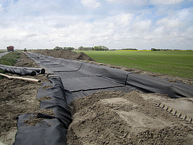 Temporary construction road reinforced with biaxial geofabric