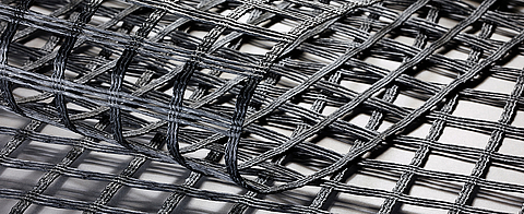 Fortrac geogrids for soil reinforcement, made from high modulus, low creep synthetic raw materials.