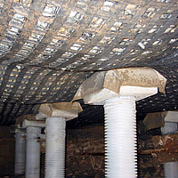 Geosynthetic reinforced earth structure over vertical support members from below