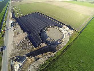 Optimize wind farm construction: geogrid-reinforced access roads & crane parking areas
