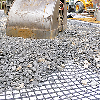  Excavator lays ballast and gravel on Basetrac® Duo-C geocomposite