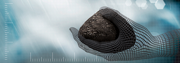 Hand holds stone for geotextile solutions
