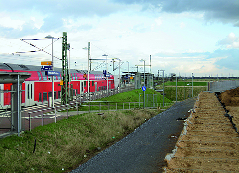 Railway station with an outdoor area and a moving train
