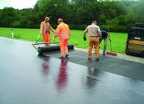 HaTelit is being laid by workers on a country road