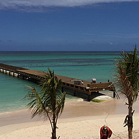 SoilTain Tube under a pier in the water on a tourist beach as a breakwater.